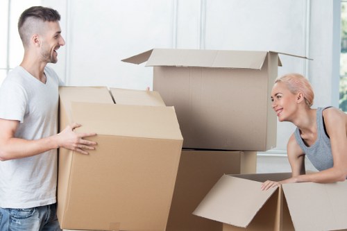Professional movers carrying furniture during a Temple relocation