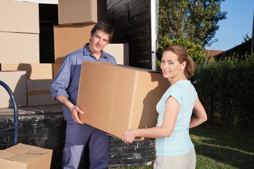 Movers carrying furniture down stairs during a flat removal in Temple
